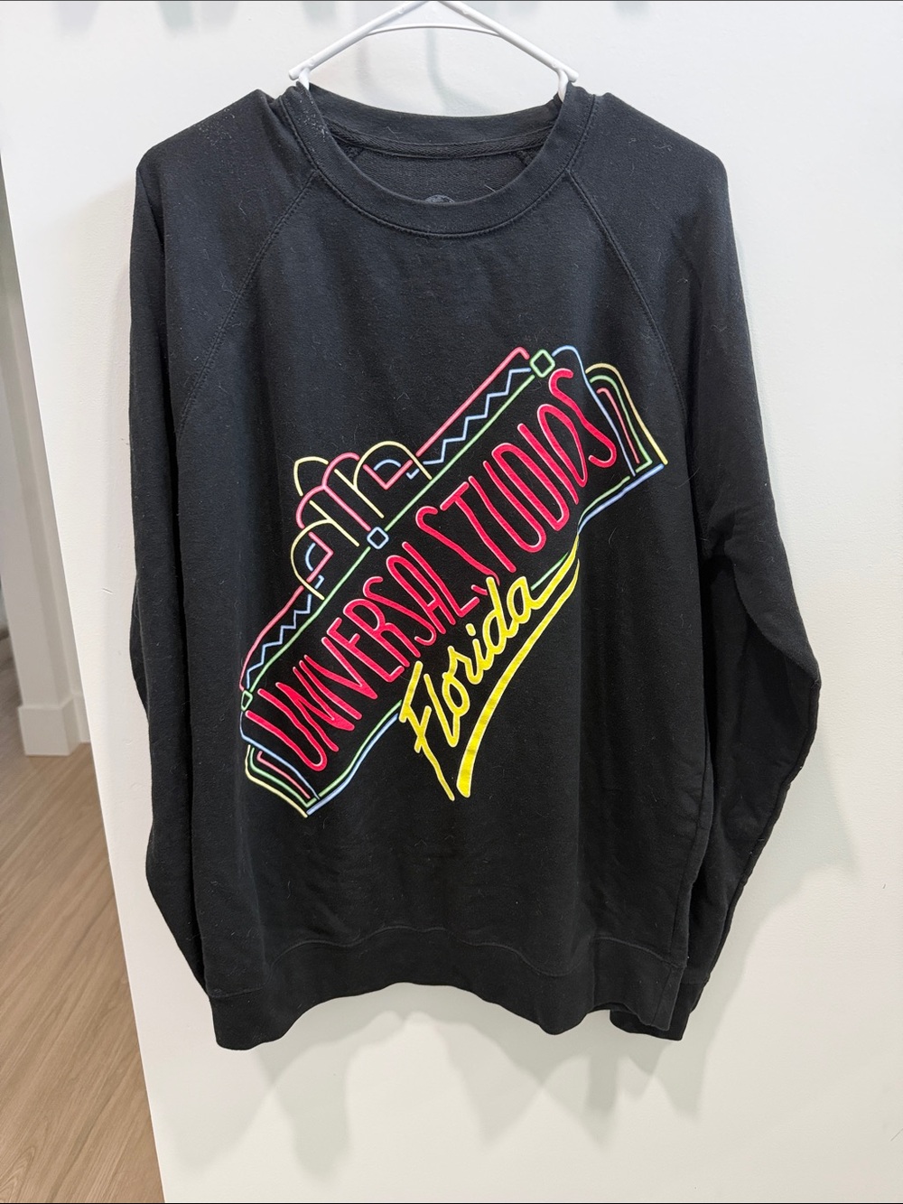 Universal Black Crewneck Sweatshirt with Neon Script
